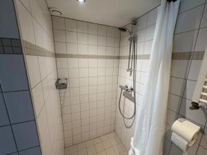 a bathroom with a shower with a shower curtain at Seasons in Warmenhuizen