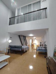 a large room with a bed and a staircase at Quiet place with duplex room in Ban Kohong