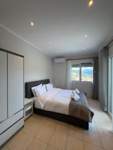 a bedroom with a bed and a large window at Panorama House in Pramanta