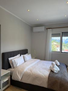 a bedroom with a bed with two towels on it at Panorama House in Pramanta +20 photos