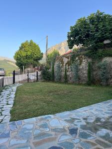 a stone walkway next to a stone wall at Panorama House in Pramanta