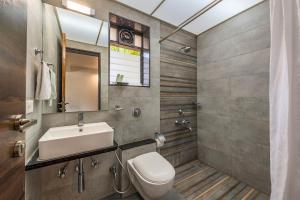 a bathroom with a sink and a toilet at Palmwoods Retreat in Pune +43 photos