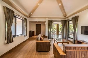 a living room with a couch and a tv at Palmwoods Retreat in Pune
