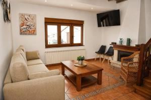 a living room with a couch and a table at El Carloto Lanchares in Lanchares