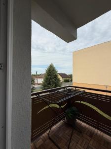a view of a balcony with a table and a plant at Harmony Suite Apartment in Pápa