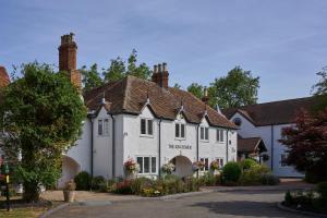 a large white building with flowers in front of it at The Kingfisher in Bedford