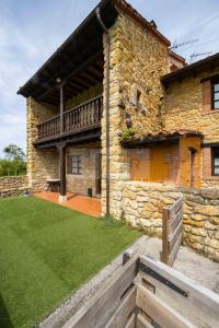 a stone building with a deck on the side of it at La Helguera By Silastur in Colombres