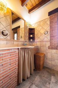 a bathroom with a sink and a mirror at La Helguera By Silastur in Colombres +36 photos