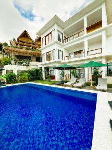 a villa with a swimming pool in front of a house at Garden Hill Views in Kuta Lombok +12 photos