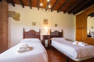 a bedroom with two beds in a room at La Helguera By Silastur in Colombres