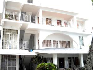 a large white building with balconies on it at Ven OCEAN VIEW in Grand-Baie