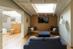 a living room with a blue couch and a tv at Aparthotel All'Orologio in Peschiera del Garda