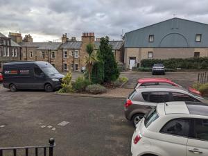 a group of cars parked in a parking lot at Stylish Edinburgh Studio in Edinburgh