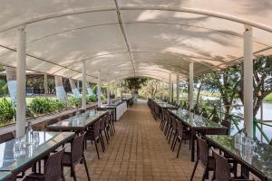 a row of tables and chairs under a tent at Palmwoods Retreat in Pune