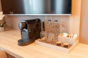a toaster sitting on a counter next to glass bottles at OPUS Batumi in Batumi +59 photos