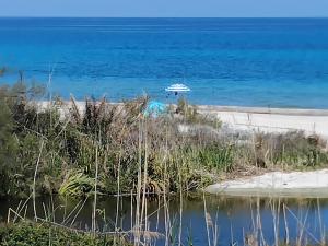 a boat in the water next to a beach at Casa Ady in San Teodoro