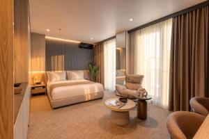 a hotel room with a bed and a chair at OPUS Batumi in Batumi