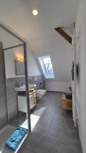 a bathroom with a shower and a sink and a toilet at Ferienwohnung Melle - Westerhausen in Melle