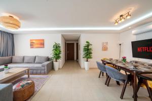 a living room with a couch and a table at Atlantic Blue 3BR Ocean View, Rabat Corniche in Rabat