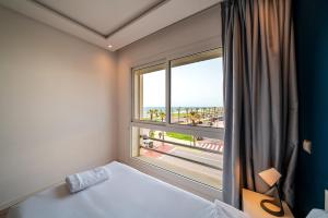 a bedroom with a window with a view of the ocean at Atlantic Blue 3BR Ocean View, Rabat Corniche in Rabat