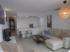 a living room with a couch and a table at Espartan Lux Juan Griego in Juangriego