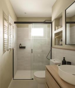 a bathroom with a shower and a toilet and a sink at Espartan Lux Juan Griego in Juangriego