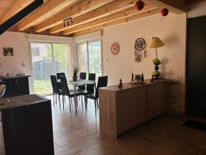 a kitchen and dining room with a table and chairs at Chalet de montagne, très confortable, neuf in LʼArgentière-la-Bessée