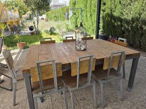 a wooden table with two chairs and a lamp at Eva luna san juan in Alicante