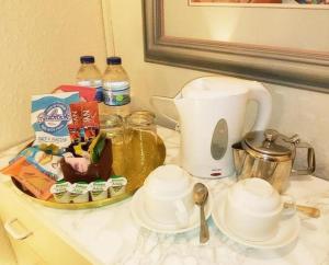 a counter top with a coffee maker and a tea kettle at OYO Lily Hotel Blackpool in Blackpool