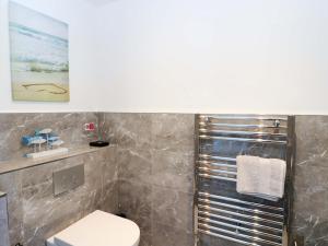 a bathroom with a toilet and a shower at Post Cottage in Arisaig +21 photos