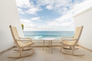 two chairs and a table in front of a window at Iberostar Selection Lanzarote Park in Playa Blanca