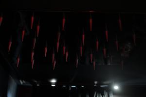 a dark room with red lights on the ceiling at Love Krak-Off - BDSM Old Town in Krakow