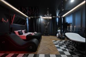a black room with a bed and a checkered floor at Love Krak-Off - BDSM Old Town in Krakow +95 photos