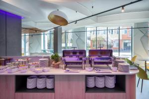 a table with plates and bowls on top at Prize by Radisson, Gdansk in Gdańsk