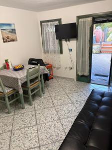 a living room with a table and a couch at Casa Ady in San Teodoro