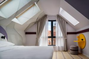 a bedroom with a white bed and a large window at Prize by Radisson, Gdansk in Gdańsk +30 photos
