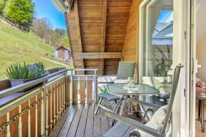 a patio with a table and chairs on a deck at Ferienwohnung Belchenzeit in Münstertal