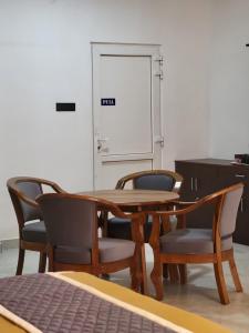 a table and chairs in a room with a door at The heights holidays in Kodaikānāl
