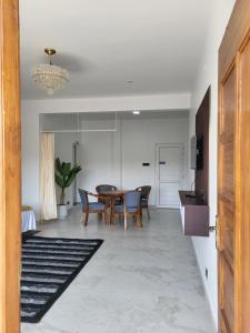 a kitchen and dining room with a table and chairs at The heights holidays in Kodaikānāl