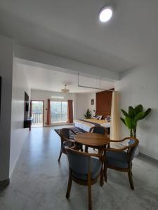 a dining room and living room with a table and chairs at The heights holidays in Kodaikānāl
