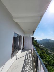 a balcony with a view of the mountains at The heights holidays in Kodaikānāl