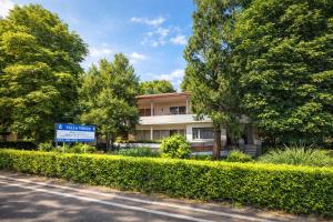 a building on the side of a road with trees at Oasi Venus Perugia e Assisi in Ponte San Giovanni