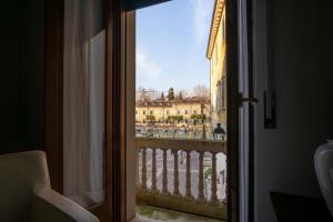 a view of a city from an open window at Aparthotel All'Orologio in Peschiera del Garda