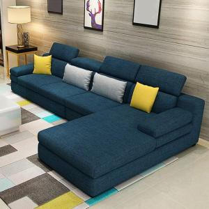 a blue couch with yellow pillows in a living room at Joster Hotel Kasangati in Kasangati