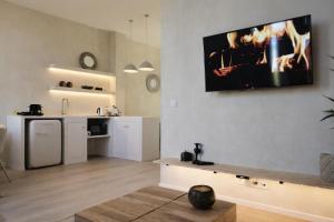 a living room with a tv hanging on the wall at SLEEP INN ANTWERP - Short & Longterm rentals in Antwerp +134 photos