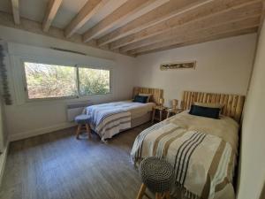 a bedroom with two beds and a window at Pin Bleu in Moliets-et-Maa +28 photos