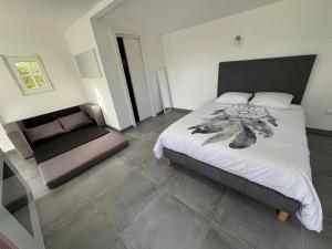 a bedroom with a bed and a chair in it at Maison entière in Dax