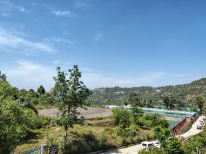 a view of a river with a train on it at Pinewood Sunrise Homestay Kasauli by Splendid Retreat Hotels in Kasauli