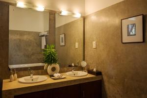 a bathroom with two sinks and a large mirror at Ranna Beach House in Ranna +25 photos
