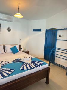 a bedroom with a bed and a blue curtain at Check Point in Unawatuna